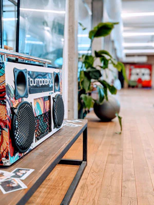Graffiti-painted boombox on a wooden bench
