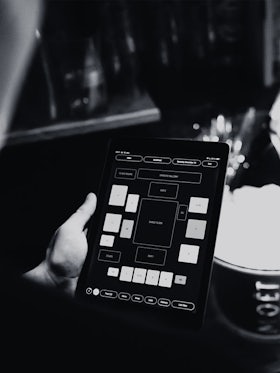 Employee holding using the table booking service in Nyx on an iPad